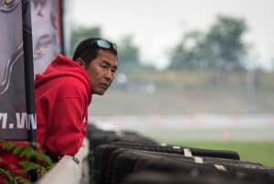 keiichi tsuchiya leaning at track