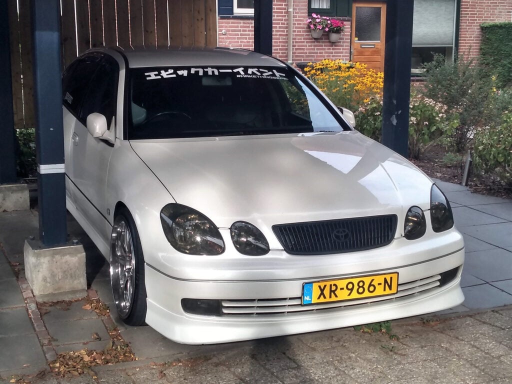 Toyota Aristo – Everything You Need To Know - Image A white car parked under a covered garage.